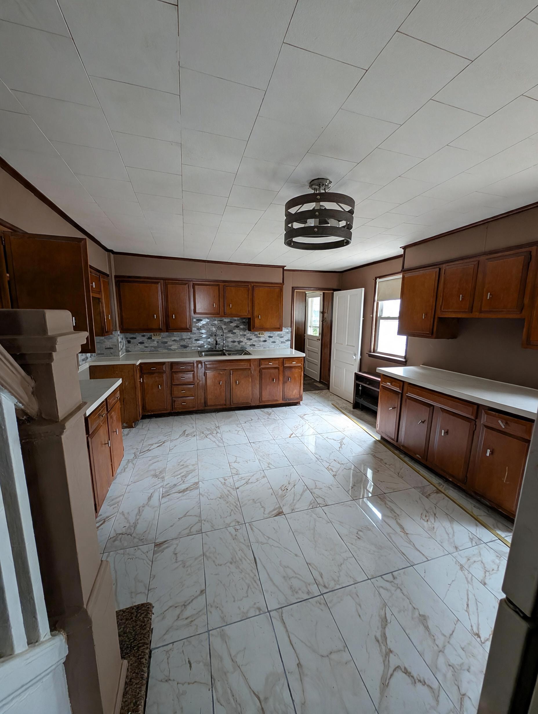 Full kitchen with pendant light and hexagon backsplash