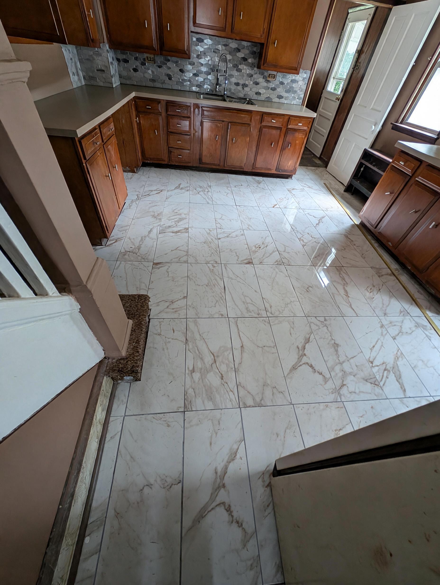 Kitchen overhead view showing marble tile floor and cabinets