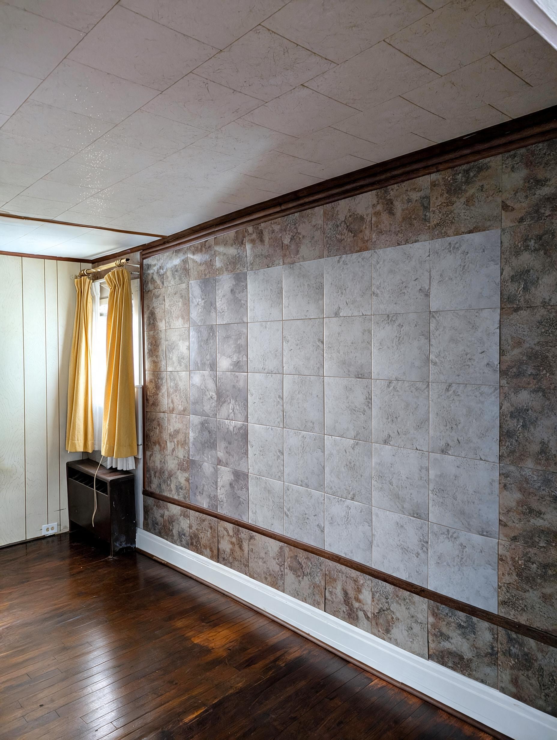 Living room with stone tile accent wall and gold curtains