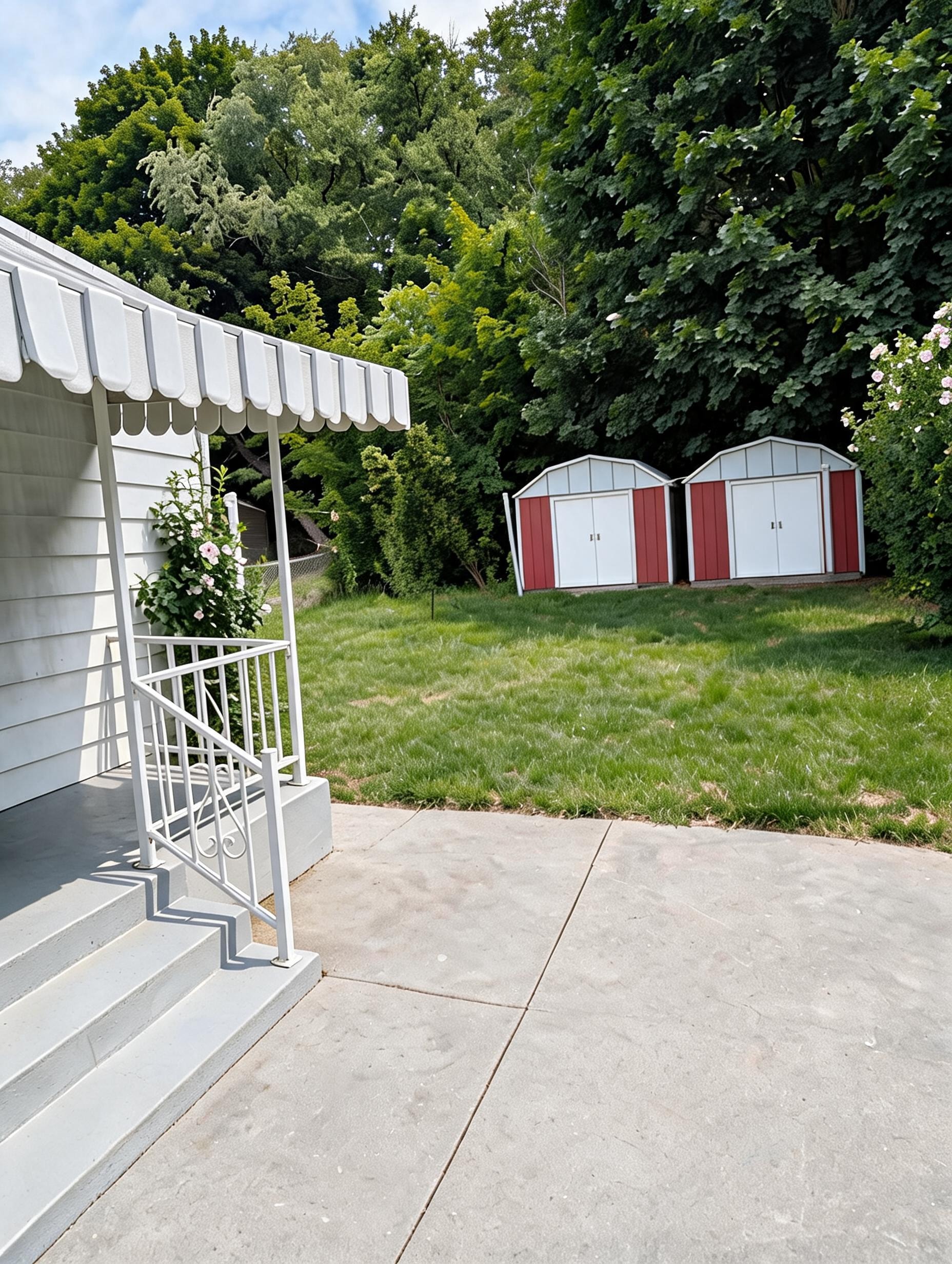 Rear patio with awning and storage sheds